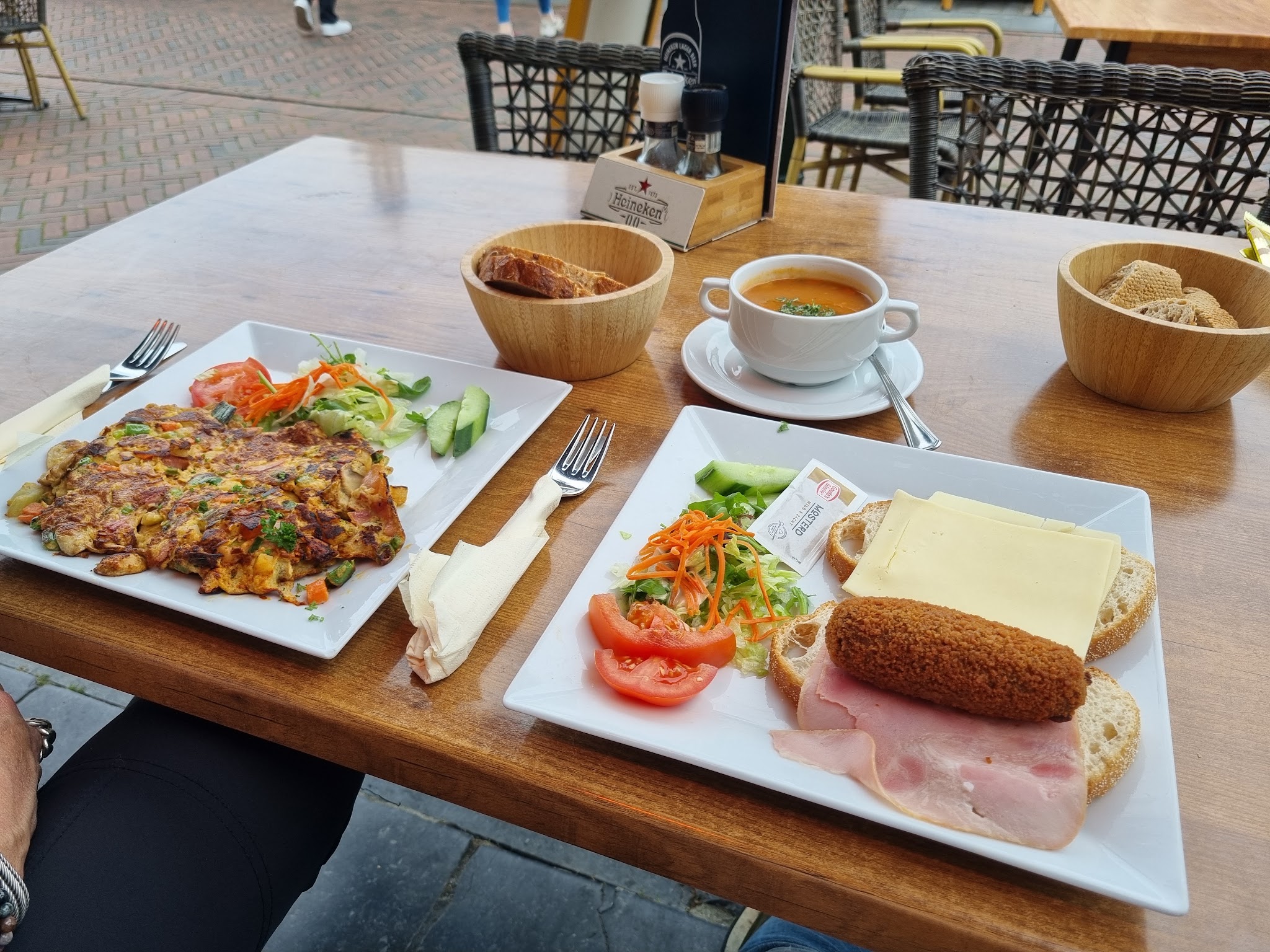 Lunchgerechten met brood, salade en koffie op een terrastafel